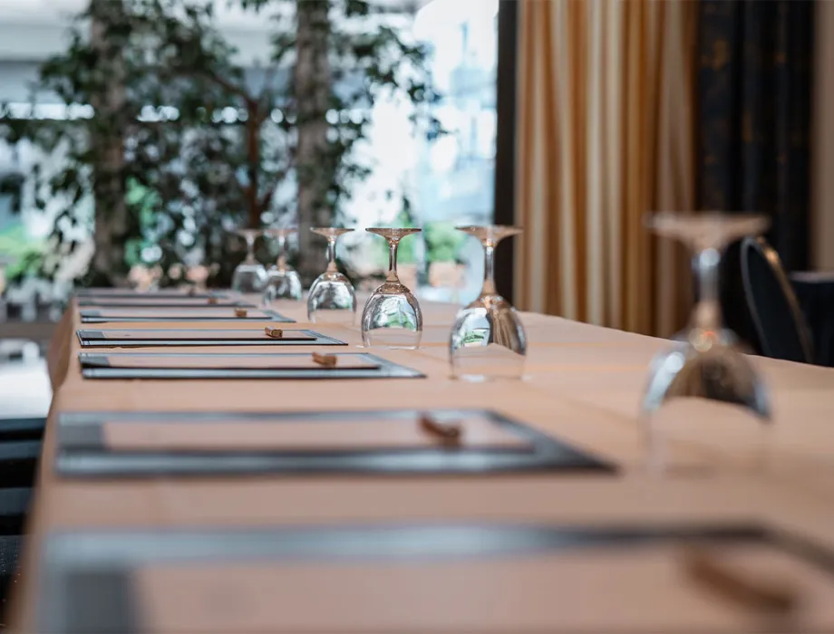 Set conference table with writing pads and upturned glasses in the conference room of the Rugard Thermal Strandhotel.