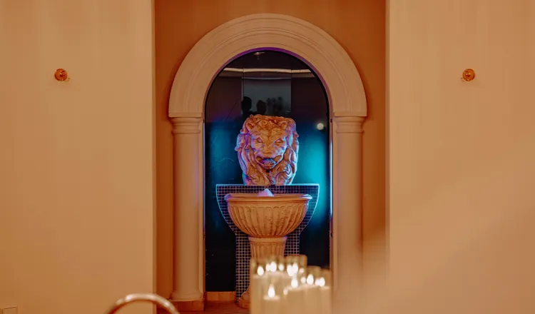 The interior of the sauna and pool area, decorated with candles and warm lighting, at the Rugard Thermal Strandhotel