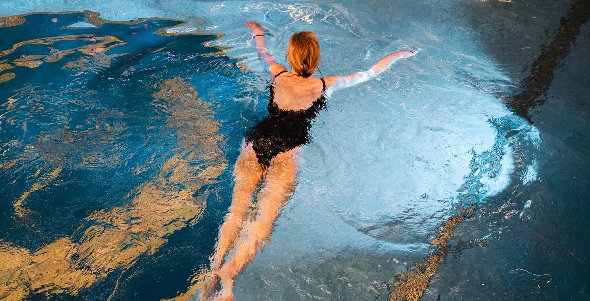 Hotel guest enjoying a relaxing swim in the pool at Rugard Strandhotel Binz on Rügen Island.